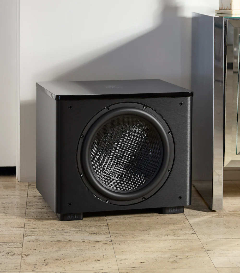 Official REL HT/1510 Predator shown in a styled room setting.