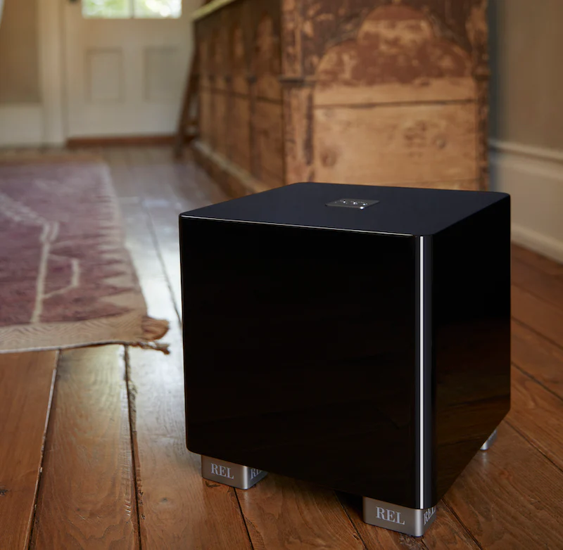 Official REL T/5x shown in a styled room setting.
